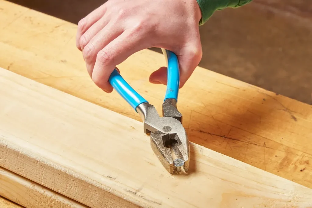An Image showing using Pliers for extra grip to remove a screw with a stripped head